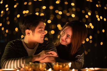 young Asian couple in night celebration with romantic love together, happy holiday Christmas party