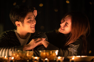 young Asian couple in night celebration with romantic love together, happy holiday Christmas party
