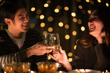 young Asian couple in night celebration with romantic love together, happy holiday Christmas party