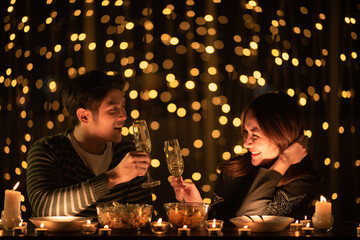 young Asian couple in night celebration with romantic love together, happy holiday Christmas party