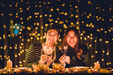 young Asian couple in night celebration with romantic love together, happy holiday Christmas party