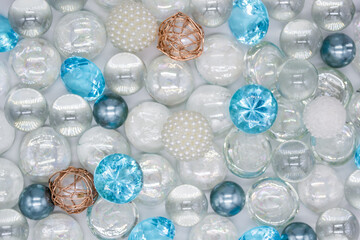 Beautiful background of transparent, light blue glass beads, crystals and white pearls. Copy space