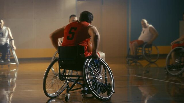 Wheelchair Basketball Game Court: Active Professional Players Competing, Passing, Shooting Ball, Competing. Determination, Inspiration, and Skill of a People with Disability. Slow Motion
