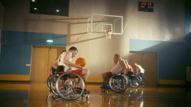 Wheelchair Basketball Game Court: Players Competing, Dribbling, Shooting it Successfully, Score Goal Points. Determination, Skill of People with Disability. Energetic Fast Paced Wide Shot