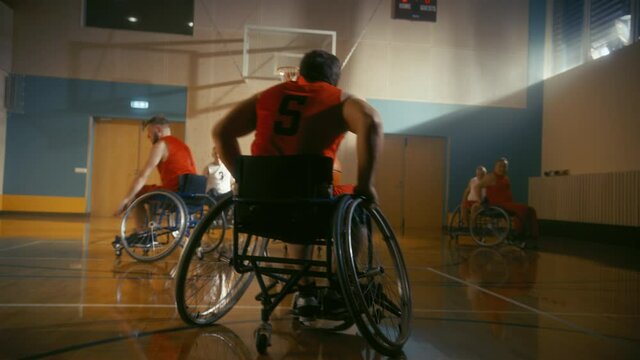 Wheelchair Basketball Game Court: Paraplegic Professional Players Competing, Passing, Shooting Ball. Determination, Inspiration, and Skill of a People with Disability. Slow Motion