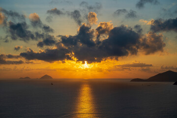 Morning sky, clouds, sun and sea water at dawn