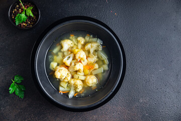 cauliflower soup vegetables first course vegetable broth healthy meal diet snack on the table copy space food background rustic. top view keto or paleo diet veggie vegan or vegetarian food no meat