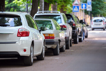 Fototapeta na wymiar City traffic with cars parked in line on street side