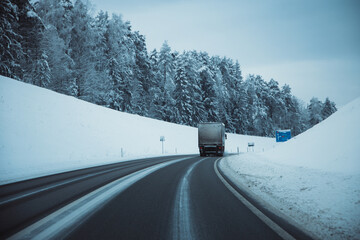 Winter asphalt road. Winter road and trees with snow and Latvian landscape. Soft focus on photos.