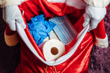 Santa Claus' bag full of toilet paper, face masks and gloves