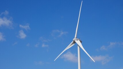 Front view of wind turbine on sunny day