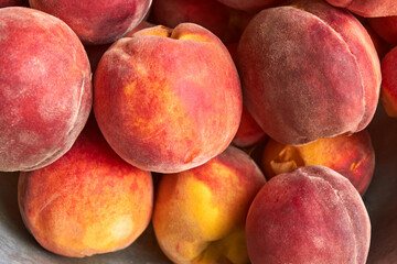 Perfect ripe orange peaches. A bunch of fresh peaches. Summer fruit harvest close-up. Summer horizontal background for design. Top view.