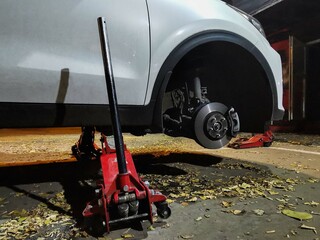 Close-up of a car without wheels on a jack on a tire service