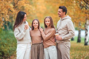 Fototapeta premium Portrait of happy family of four in autumn day