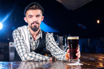 Charismatic bartender makes a cocktail in cocktail bars