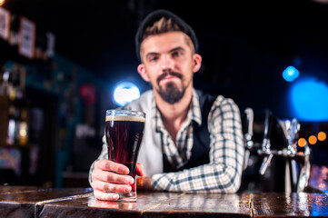 Experienced bartender adds ingredients to a cocktail in the nightclub