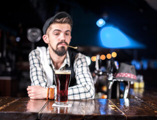 Portrait of barman mixes a cocktail in the nightclub