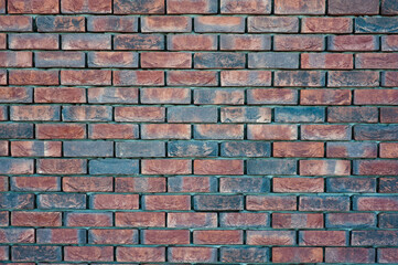 red old brick wall background, brick wall texture, structure. old broken brick, cement joints, close-up.