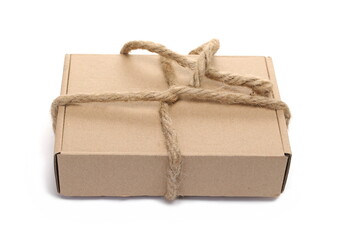 Closed cardboard box with rope bow isolated on white  