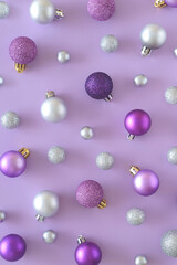 Purple Christmas background with silver and purple ornaments. New Year aesthetic concept. Flat lay.