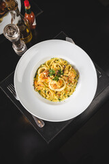 Perfect Seafood Menu Dish Plate Food Octopus Salmon, Shrimp Risotto Pasta Vegetables Salad Fish on a Dark Background