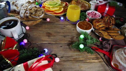Festive Christmas morning breakfast or brunch table, with traditional foods – pancakes, Belgian waffles, fried eggs, croissant, stolen, cookies, with orange juice and coffee, cinnamon rice porridge 