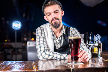 Young bartender demonstrates his professional skills