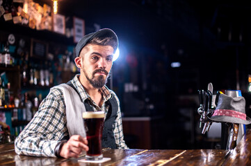 Professional bartender is pouring a drink in the bar