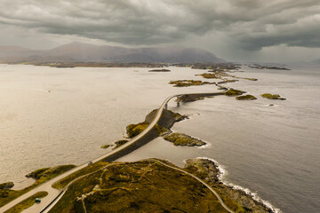 Aerial view of the Atlantic Road takes you on a unique journey close to the powerful Ocean. This Norwegian Scenic Route opened in 1989, and is considered the most beautiful road trip in the world.