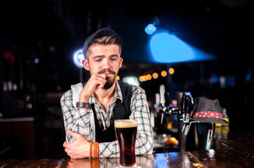 Young Female bartender formulates a cocktail in the nightclub