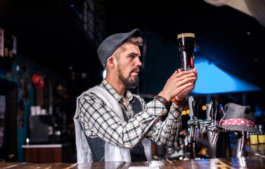 Charismatic barman demonstrates his skills over the counter on the bar