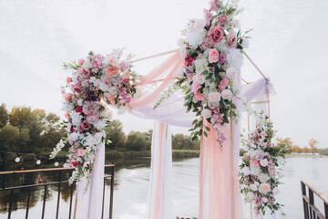 Fall wedding with pink roaming ceremony by the water on the pier