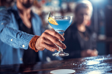 Bartender makes a cocktail in the alehouse