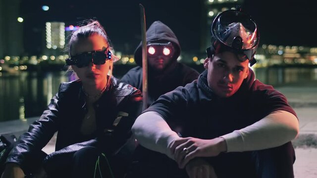 Cyberpunk style criminal group posing on a night neon city