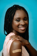 Vaccinated attractive young woman with plaster on hand