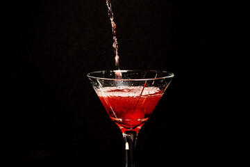 close up of martini glass with red cherry cocktail
