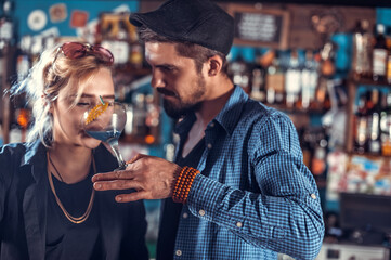 Girl bartender creates a cocktail on the public house