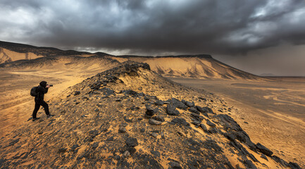 A tourist photographs the Black Desert in Bahariya. Egypt