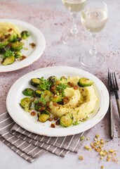 Brussels sprouts with pistachios, raisins and Skordalia (mashed potatoes). Healthy Meal preparation. Plant-based dishes. Green living. Vegan recipe. Food styling. Vegetarian cuisine