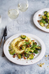 Brussels sprouts with pistachios, raisins and Skordalia (mashed potatoes). Healthy Meal preparation. Plant-based dishes. Green living. Vegan recipe. Food styling. Vegetarian cuisine