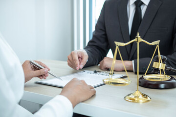Male lawyer or counselor discussing negotiation legal case with client meeting with document...