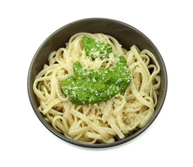 Italian Food. Pasta spaghetti with original pesto green sauce in Genoa (Genova) Italy on white plate background, Pasta with basil pesto herbs background.
