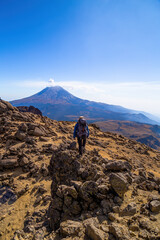 A man climbing a hill in the mountains of iztaccihuatl volcano