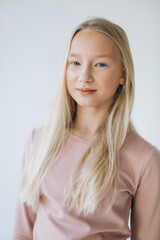 Portrait of blondie young caucasian girl in studio. Fashionable portrait of pretty teen girl