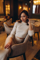 Beautiful woman portrait in luxury restaurant. Rich stylish caucasian brunette girl