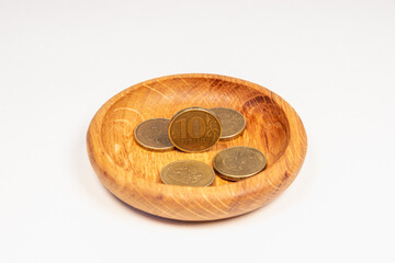 Small, metallic money in wooden dishes. Russian money.