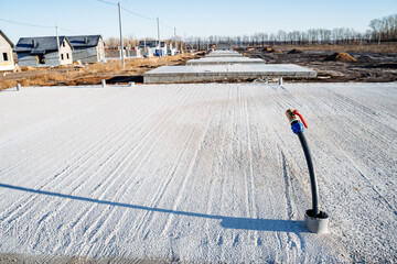 A hole in the foundation of the house for water supply. A water pipe sticks out of the floor of the...