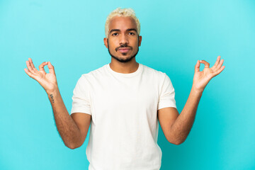Naklejka premium Young Colombian handsome man isolated on blue background in zen pose