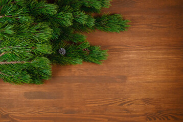 Christmas tree branch on wooden background. Xmas and Happy New Year theme. Flat lay, top view. Copy space