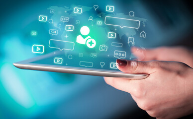 Close-up of a hand using tablet, social media concept
